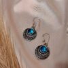 Nakkashi blue oxidised circular earrings with engraved detailing and central stone