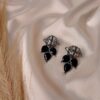 Nayra black oxidised floral earrings with teardrop stone design and antique finish