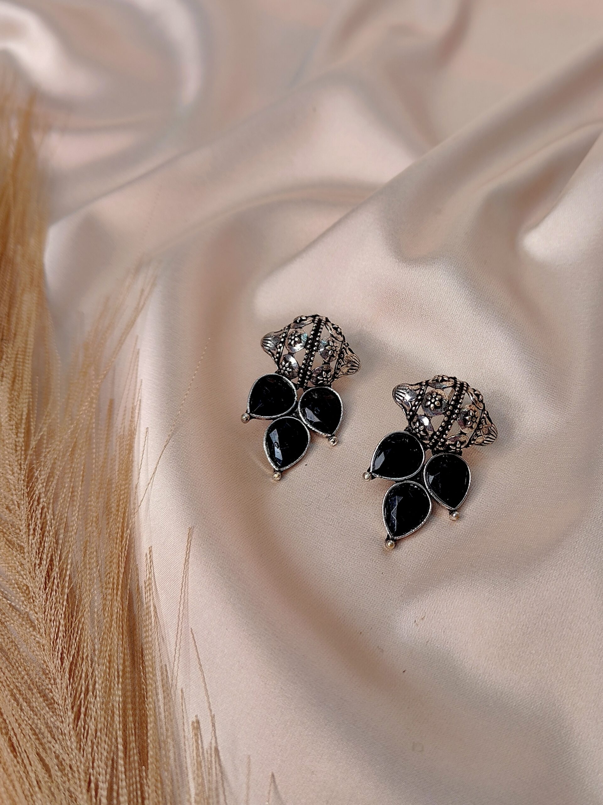 Nayra black oxidised floral earrings with teardrop stone design and antique finish