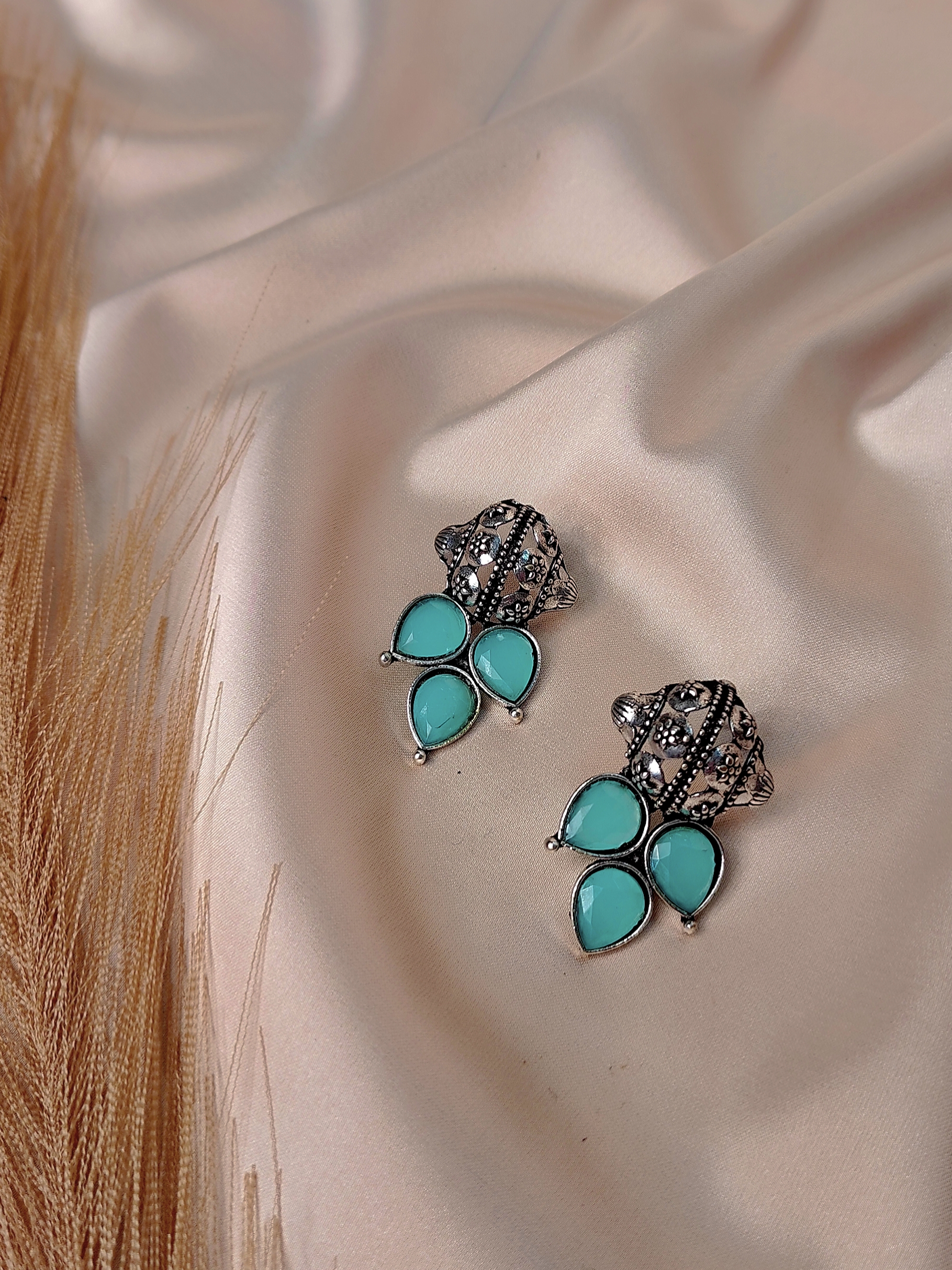 Nayra blue oxidised floral earrings with teardrop stone design and antique finish
